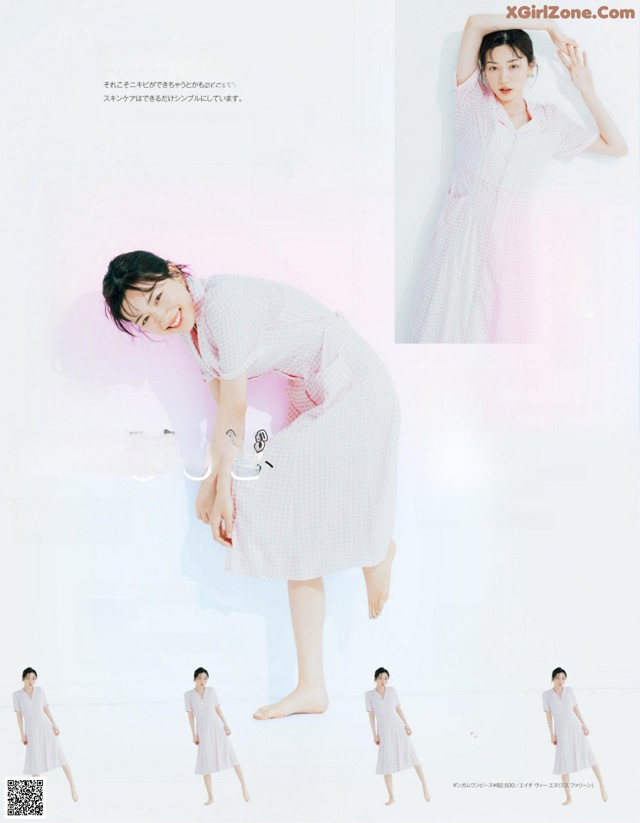 A woman in a pink and white checkered dress posing for a magazine.