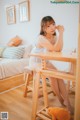 A woman sitting at a table with a teddy bear.